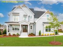 Charming two-story home featuring a mix of board and batten and shake siding, complemented by professional landscaping at 1036 Smoke Willow Way, Rolesville, NC 27571