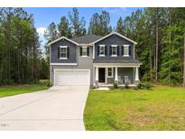 Charming two-story home featuring a covered front porch and a two-car garage at 120 Rocking Horse Ln, Sanford, NC 27332