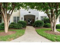 Welcoming entrance with lush landscaping leading to the front door at 1301 Durlain Dr # 103, Raleigh, NC 27614
