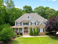 Stunning two-story home with manicured lawn and charming stone and siding exterior at 1308 Woodgate Manor Ct, Raleigh, NC 27614