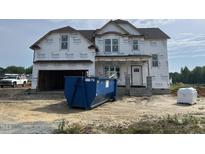 New two-story home with Tyvek wrap, covered entrance, and an attached two-car garage at 151 Retreat Run, Smithfield, NC 27577