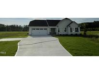 Charming single-Gathering home featuring a two-car garage and a well-manicured lawn at 180 Tulipfield Way, Benson, NC 27504