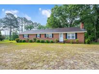 Charming single-story brick home featuring a cozy front yard and traditional curb appeal at 202 Hamilton Rd, Bunnlevel, NC 28323