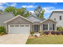 Charming single-story home featuring stone accents, a two-car garage, and a well-manicured lawn with beautiful landscaping at 2634 Yellow Pine Rd, Raleigh, NC 27616