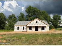 An exterior elevation showcasing a partially built home with a yard and surrounding trees at 275 Atkins Rd, Cameron, NC 28326