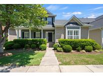 Charming two-story home features a landscaped yard and inviting covered porch perfect for relaxing at 308 Minton Valley Ln, Cary, NC 27519
