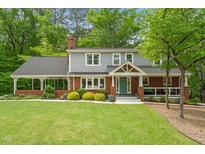 Charming two-story home with a brick facade, beautiful landscaping, and a welcoming front porch at 504 S Dixon Ave, Cary, NC 27511