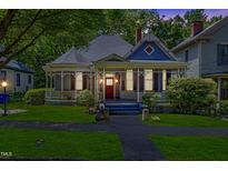 Charming historic home with a classic wraparound porch and lush green lawn at 517 N East St, Raleigh, NC 27604