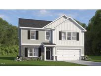 Charming two-story home showcasing a mix of gray siding and brick accents, plus a two-car garage at 812 Comice Pear Way, Willow Springs, NC 27592