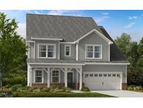 Charming two-story home featuring a covered porch, gray siding, and a two-car garage at 1020 Dillon Lake Dr, Knightdale, NC 27545
