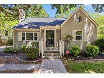 Charming single-story home with a brick facade, landscaped yard, and inviting front entrance at 1304 N Duke St, Durham, NC 27701