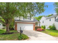 Charming home with a two-car garage, mature tree, landscaped yard, and brick accents at 248 Inkster Cv, Raleigh, NC 27603