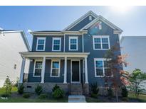 Beautiful two-story home with a covered porch and manicured landscaping at 2918 Heirloom Way, Apex, NC 27502