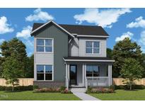 Charming two-story home featuring vertical and horizontal siding, a covered porch, and professionally landscaped front yard at 333 Parkland Dr, Pittsboro, NC 27312