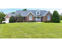 Charming brick home featuring a well manicured lawn and inviting front porch at 4005 Olde Waverly Way, Fuquay Varina, NC 27526