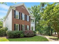 Charming brick home with black shutters and manicured landscaping at 405 Commons Walk Cir, Cary, NC 27519