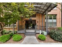 Attractive brick building entrance with steel details, landscaped plantings, and clearly marked address at 500 N Duke St # 55-105, Durham, NC 27701