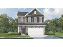 Two-story home with stone accents, a two-car garage, and a well-manicured lawn at 549 Morning Light Dr, Angier, NC 27501