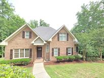 Charming brick home with manicured lawn, inviting entrance, and wood shutters at 7483 Danford Rd, Burlington, NC 27215