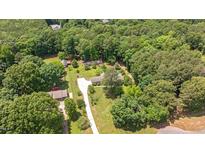 Expansive aerial view of a home surrounded by lush greenery and a long driveway at 8133 Holly Forest Rd, Wake Forest, NC 27587