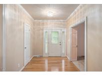 Inviting foyer with hardwood floors, decorative glass door, and neutral paint at 8133 Holly Forest Rd, Wake Forest, NC 27587