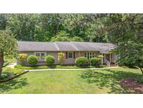 Charming single-story home featuring well-maintained landscaping and a welcoming walkway at 8133 Holly Forest Rd, Wake Forest, NC 27587