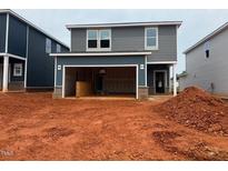 Two-story home showing the garage and gray siding at 829 Ottawa Dr, Garner, NC 27529