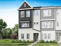 New three-story townhome showcasing a modern design, neat landscaping, and a welcoming entrance at 1037 Zelkova Ln, Chapel Hill, NC 27517