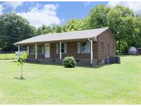 Charming brick home with a well-maintained front yard and inviting porch, creating a warm and welcoming curb appeal at 107 Rencher St, Hillsborough, NC 27278