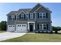 Beautiful two-story home with a well-manicured lawn and a two-car garage at 111 Bonsai Way, Four Oaks, NC 27524