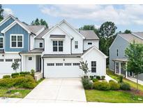 Charming two-story home with a white facade, black trim, and a two-car garage at 1240 Gemfor St, Durham, NC 27703