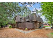 Brick townhouse with two stories, fenced porch, dormer windows, and mature landscaping at 127 Finley Forest Dr, Chapel Hill, NC 27517