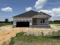 New construction features a modern facade, showcasing its architectural design and curb appeal on a sunny day at 136 Tuskeegee Dr, Smithfield, NC 27577