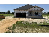 New construction home features a two-car garage, gray roof, and siding ready for a buyer's final touch at 136 Tuskeegee Dr, Smithfield, NC 27577
