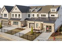 Charming townhomes with modern farmhouse-style exterior, featuring brick accents and fenced yards at 157 N District Ave # 291, Clayton, NC 27527