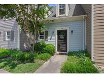 Charming home featuring a welcoming front door with a decorative wreath and landscaped yard at 1602 Township Cir, Raleigh, NC 27609