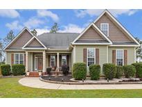 Charming home featuring manicured landscaping, a walkway, and inviting front porch at 182 Brendamoore Ct, Fuquay Varina, NC 27526
