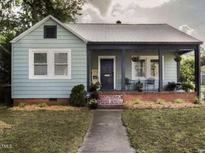 Charming single-story home featuring a covered front porch and well-maintained lawn at 200 S Pettigrew St, Raleigh, NC 27610