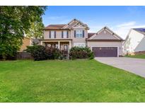 Charming two-story home features a manicured lawn and attached two car garage at 234 Lars Ln, Garner, NC 27529
