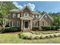Beautiful brick home with lush landscaping and a welcoming front porch at 4412 Thistlehill Ct, Raleigh, NC 27616