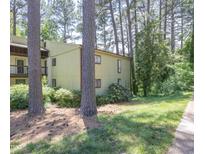 View of the home with a lawn and mature trees creating a scenic setting at 514 Pine Ridge Pl, Raleigh, NC 27609