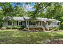Charming single-story home featuring a welcoming front porch and well-maintained landscaping at 578 Jeffries Cross Rd, Burlington, NC 27217