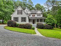 Charming two-story home boasts a landscaped yard, inviting front porch and tasteful curb appeal at 635 Buckroe Dr, Sanford, NC 27330