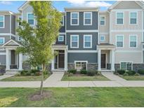 Charming townhouse featuring a well-manicured lawn and beautiful curb appeal at 6618 Perry Creek Rd, Raleigh, NC 27616
