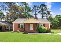 Charming brick home featuring a well-maintained front yard and traditional architectural details at 905 S 1St St, Smithfield, NC 27577