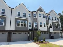 Modern townhome features a two-car garage and a sleek, two-tone facade at 1004 Regalia Rd # 3, Durham, NC 27713