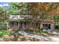 Charming brick home with a well-manicured lawn, mature trees and covered front porch at 1115 Chestnut Dr, Smithfield, NC 27577