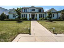 Charming home with a symmetrical facade, manicured lawn, and a welcoming walkway to the front door at 115 Founders Ridge Dr, Chapel Hill, NC 27517