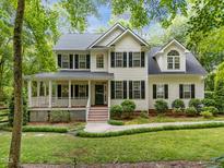 Charming two-story home with a welcoming front porch and lush landscaping at 118 Cavendish Ct, Hillsborough, NC 27278