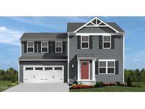 Charming two-story home featuring a two-car garage and a classic red front door at 1537 Ivy Meadow Ln, Zebulon, NC 27597